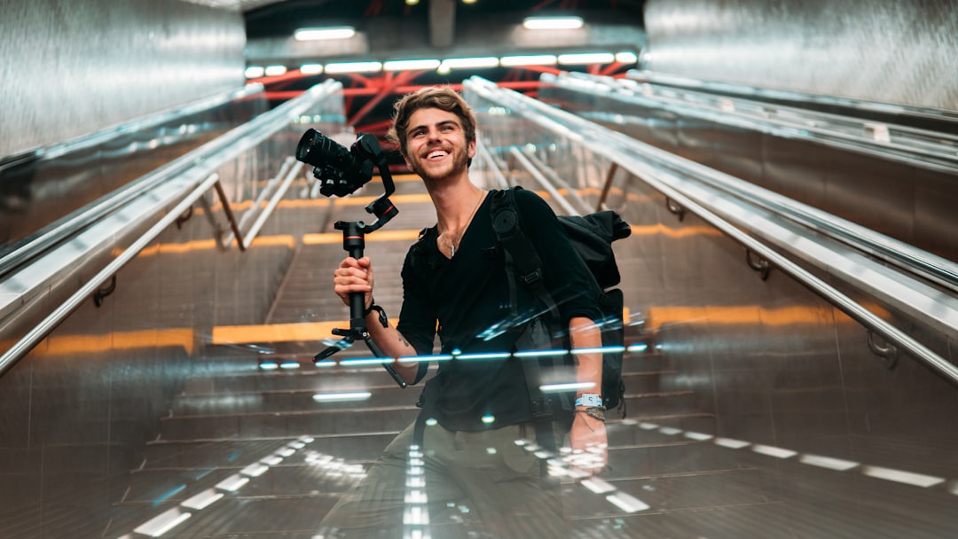 woman in black jacket holding black dslr camera