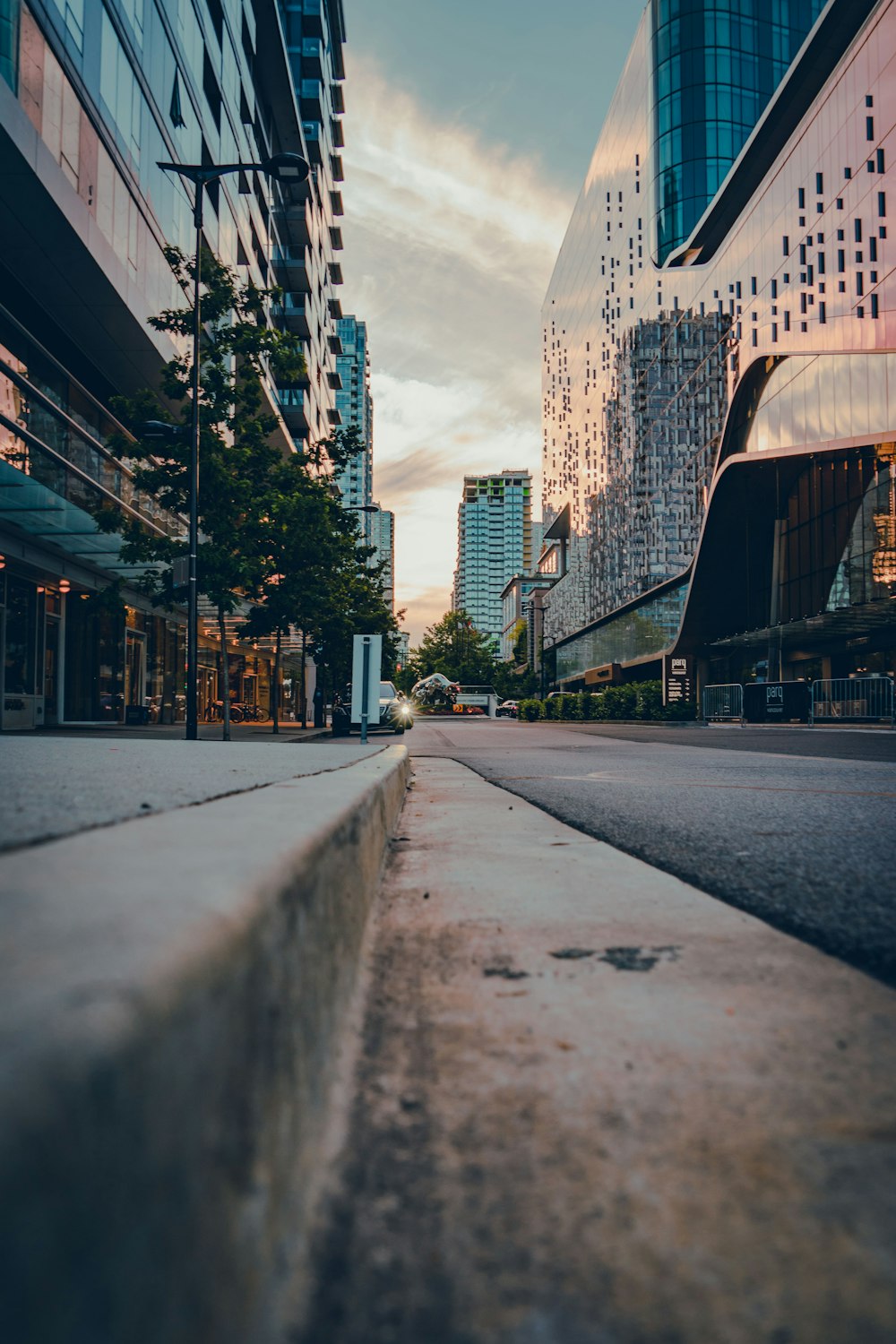 gray concrete road between high rise buildings during daytime