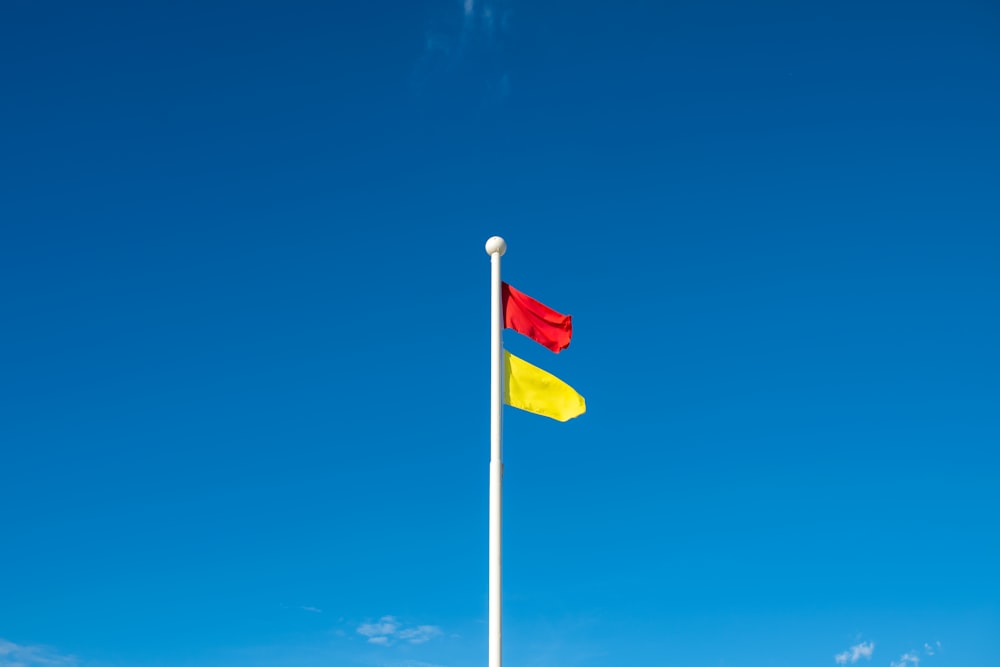 white red and blue flag under blue sky during daytime