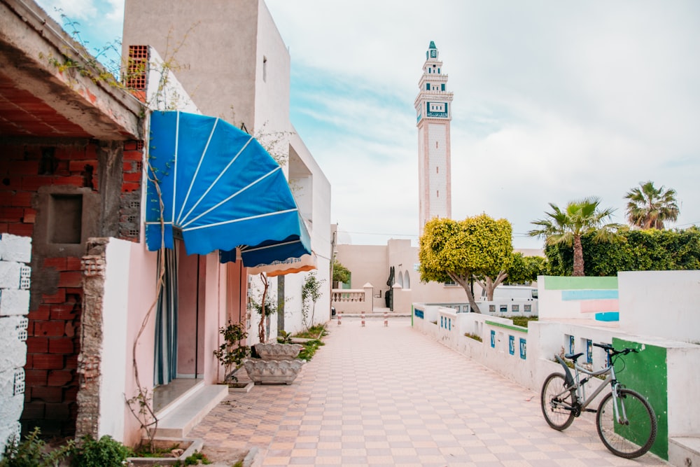 blue umbrella near white concrete building