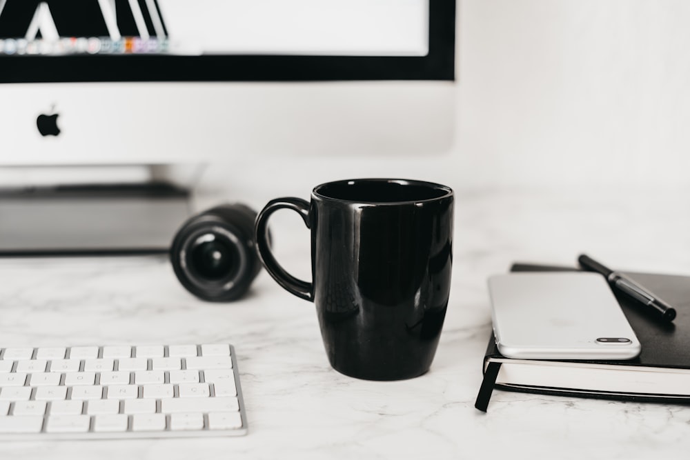 black ceramic mug on white table