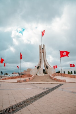 flags on brown concrete bridge during daytime