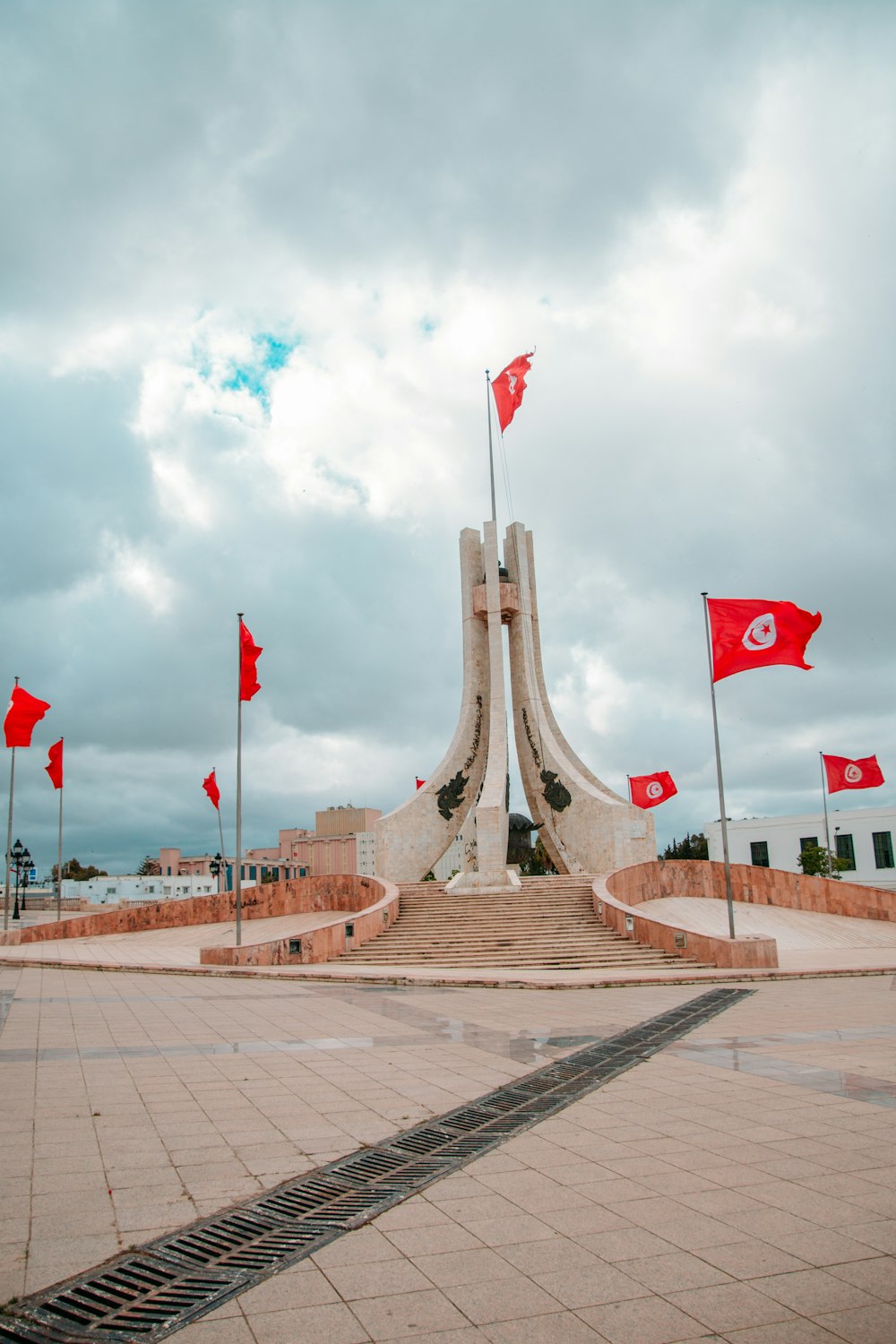 flags on brown concrete bridge during daytime