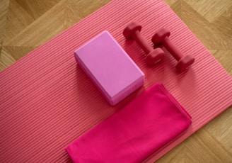 pink dumbbell on pink textile