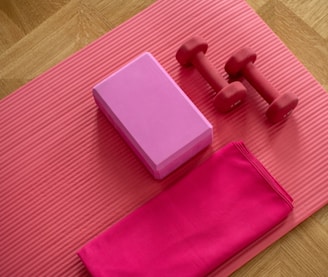 pink dumbbell on pink textile