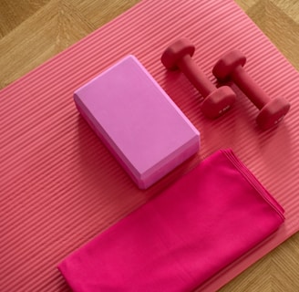 pink dumbbell on pink textile