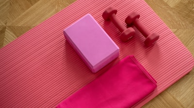 pink dumbbell on pink textile