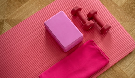 pink dumbbell on pink textile