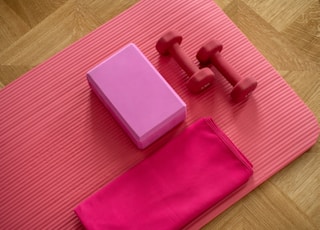 pink dumbbell on pink textile