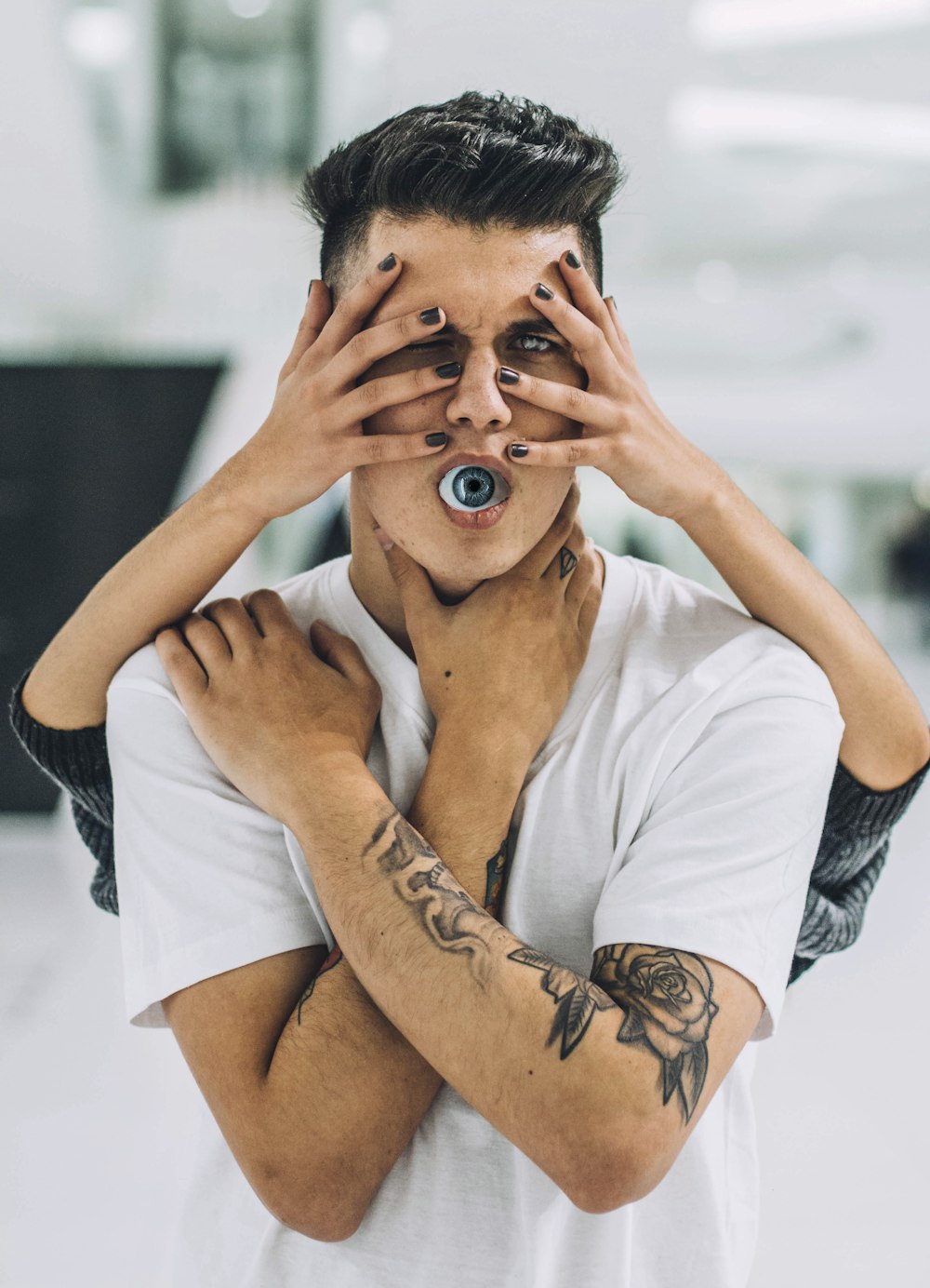 man in white t-shirt with tattoo on his right arm