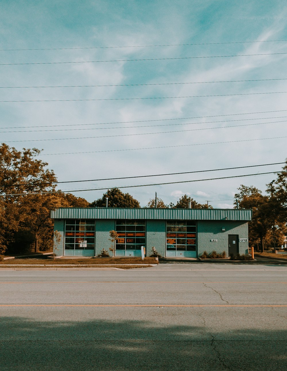 green and white concrete building near trees during daytime