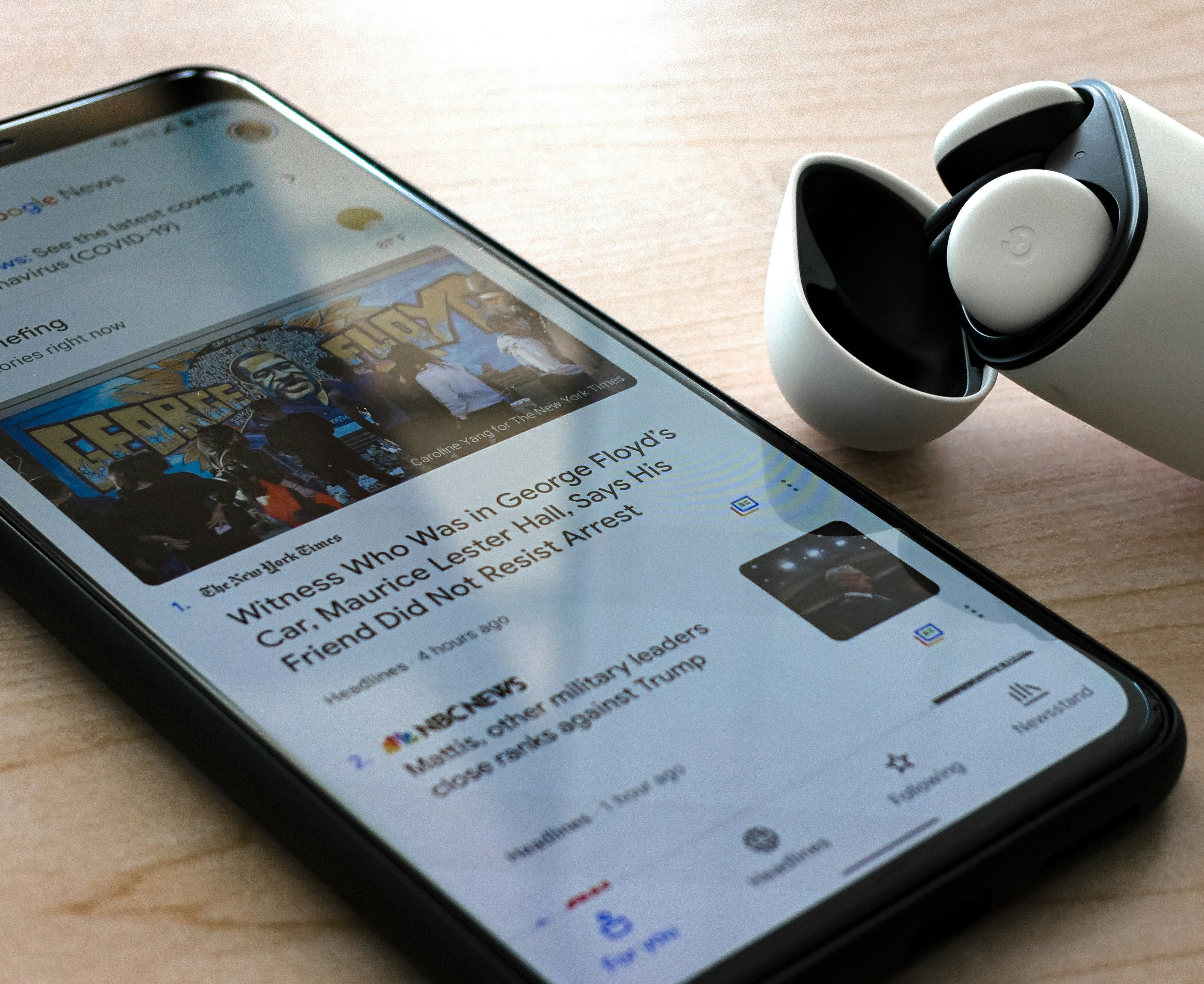 A Google Pixel 4 XL displays news of the Nationwide Protests while resting next to a pair of Pixel Buds

Credit: @upgradeur_life   www.instagram.com/upgradeur_life
