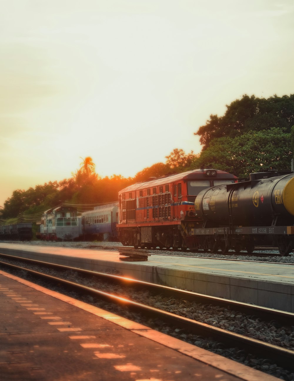 red and black train on rail tracks during daytime