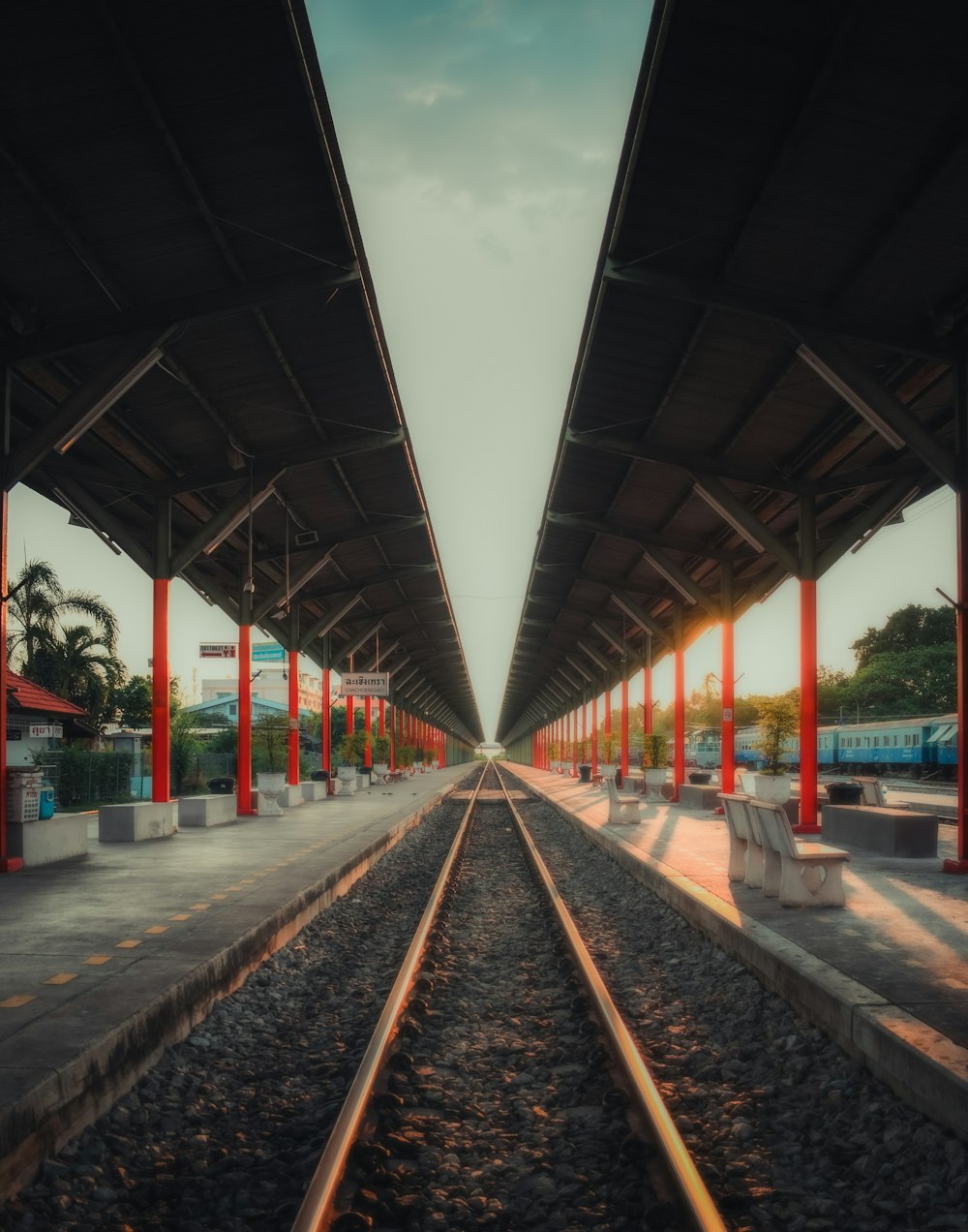 train rail under gray sky during daytime