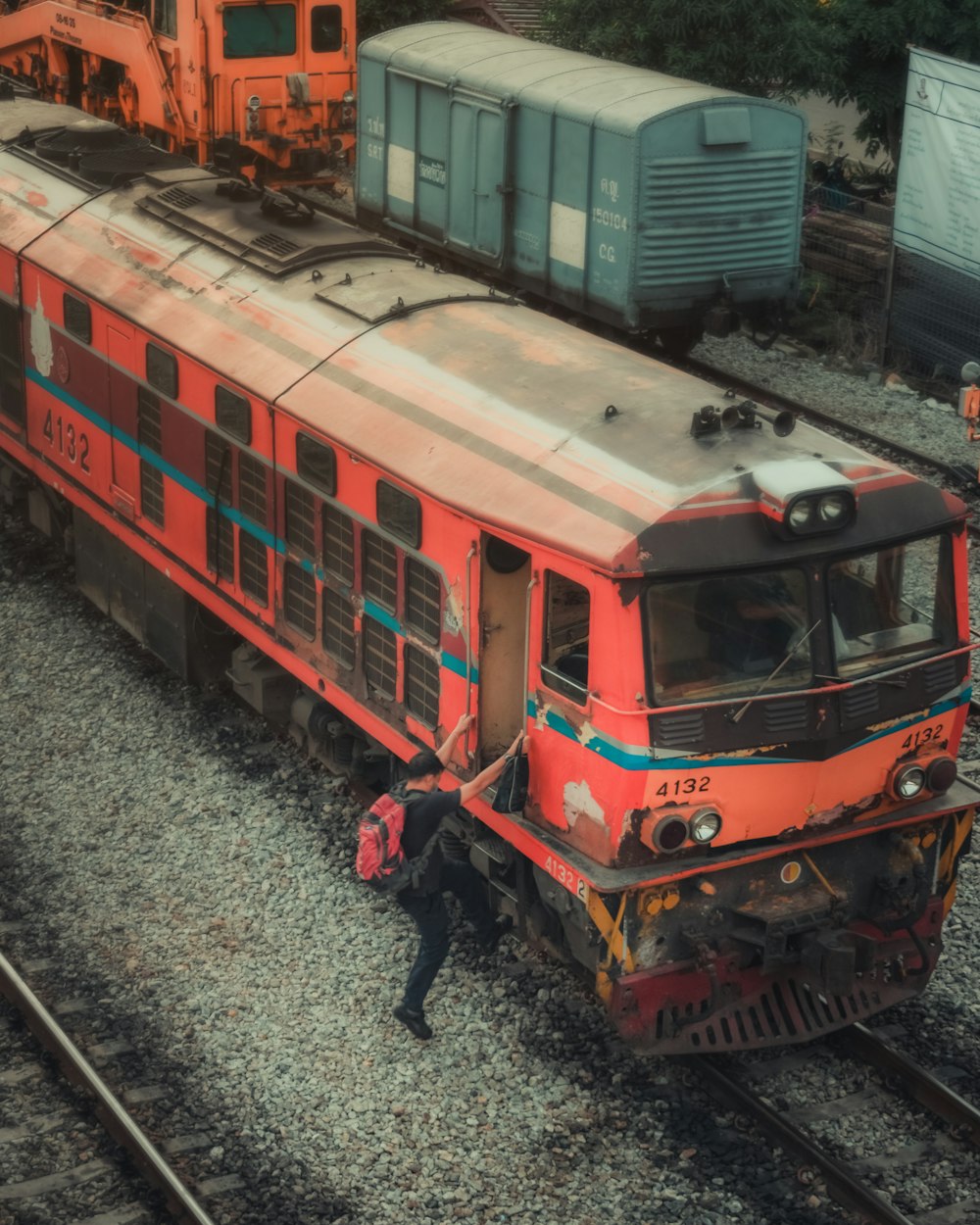 red and white train on rail tracks during daytime