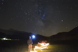 Mina Vilaiphanh gently channeling energy under a starry night sky with aurora-like light effects.