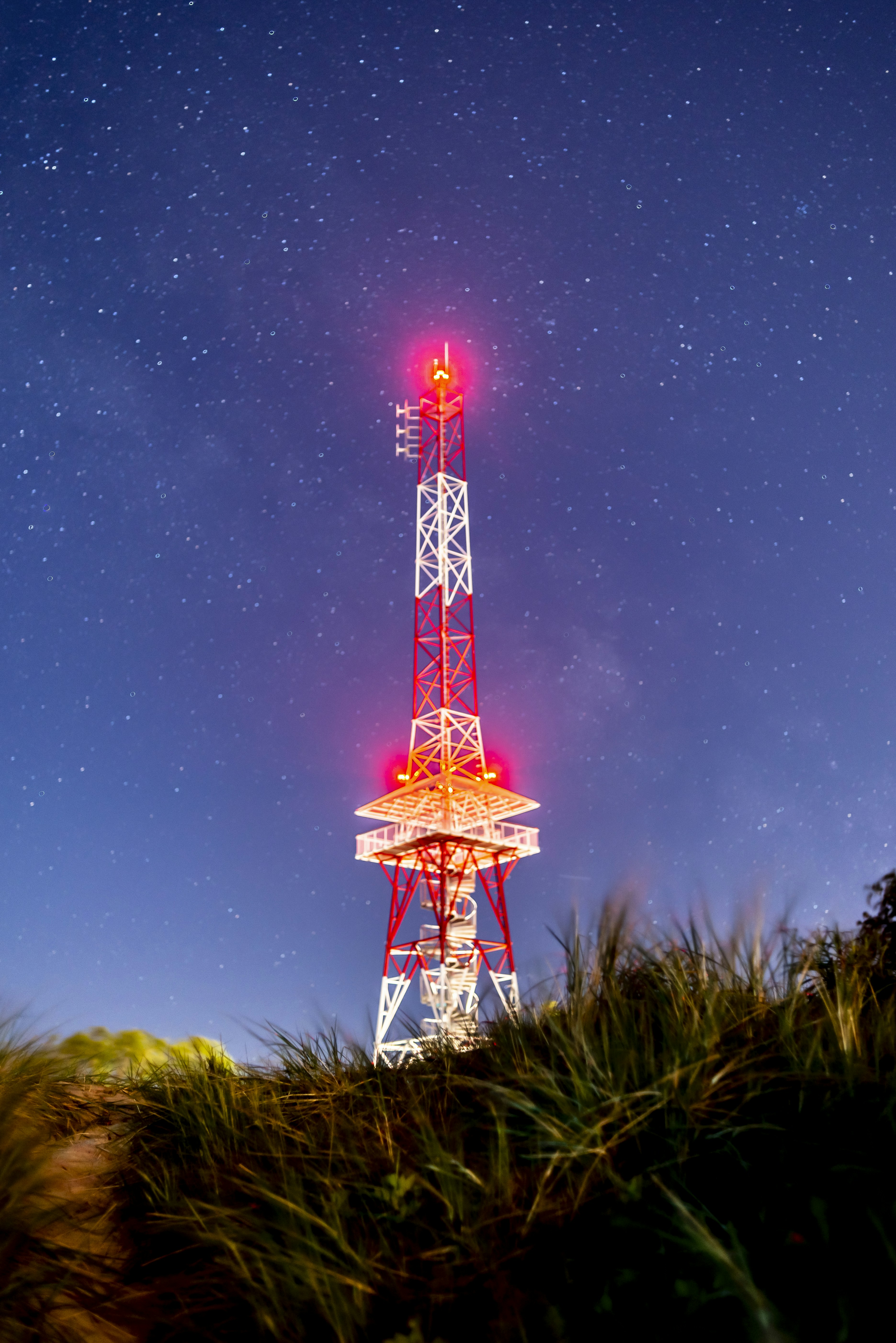 red and white tower under starry night
