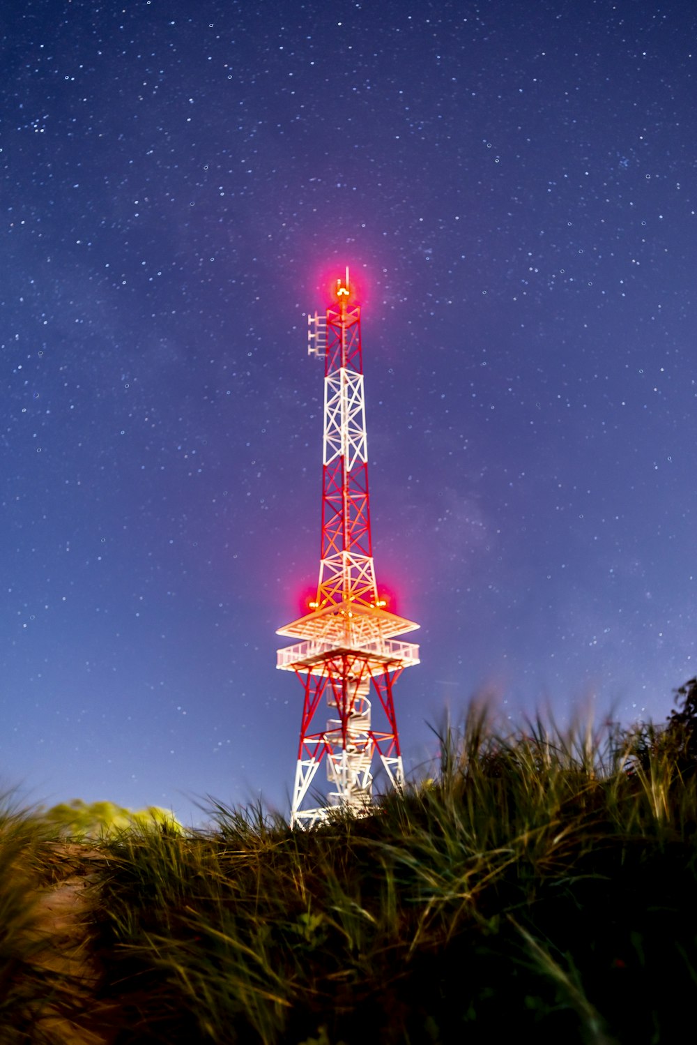 red and white tower under starry night