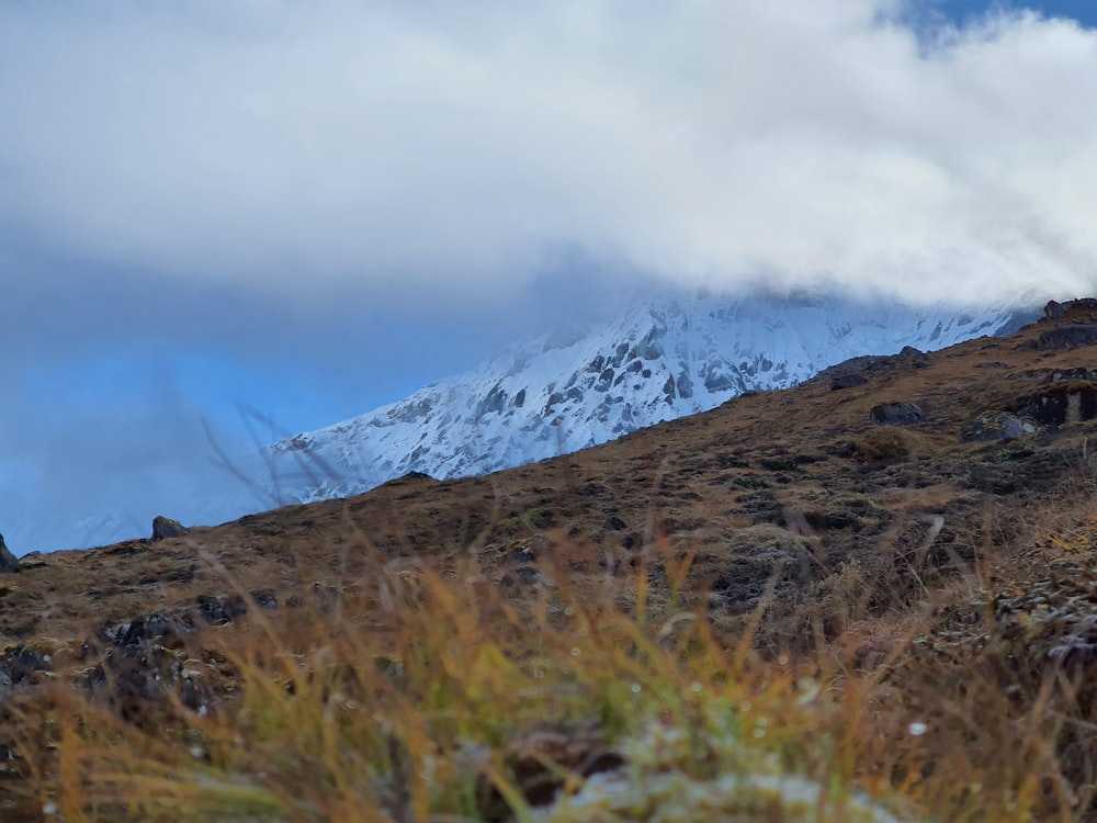 snow covered mountain under cloudy sky during daytime