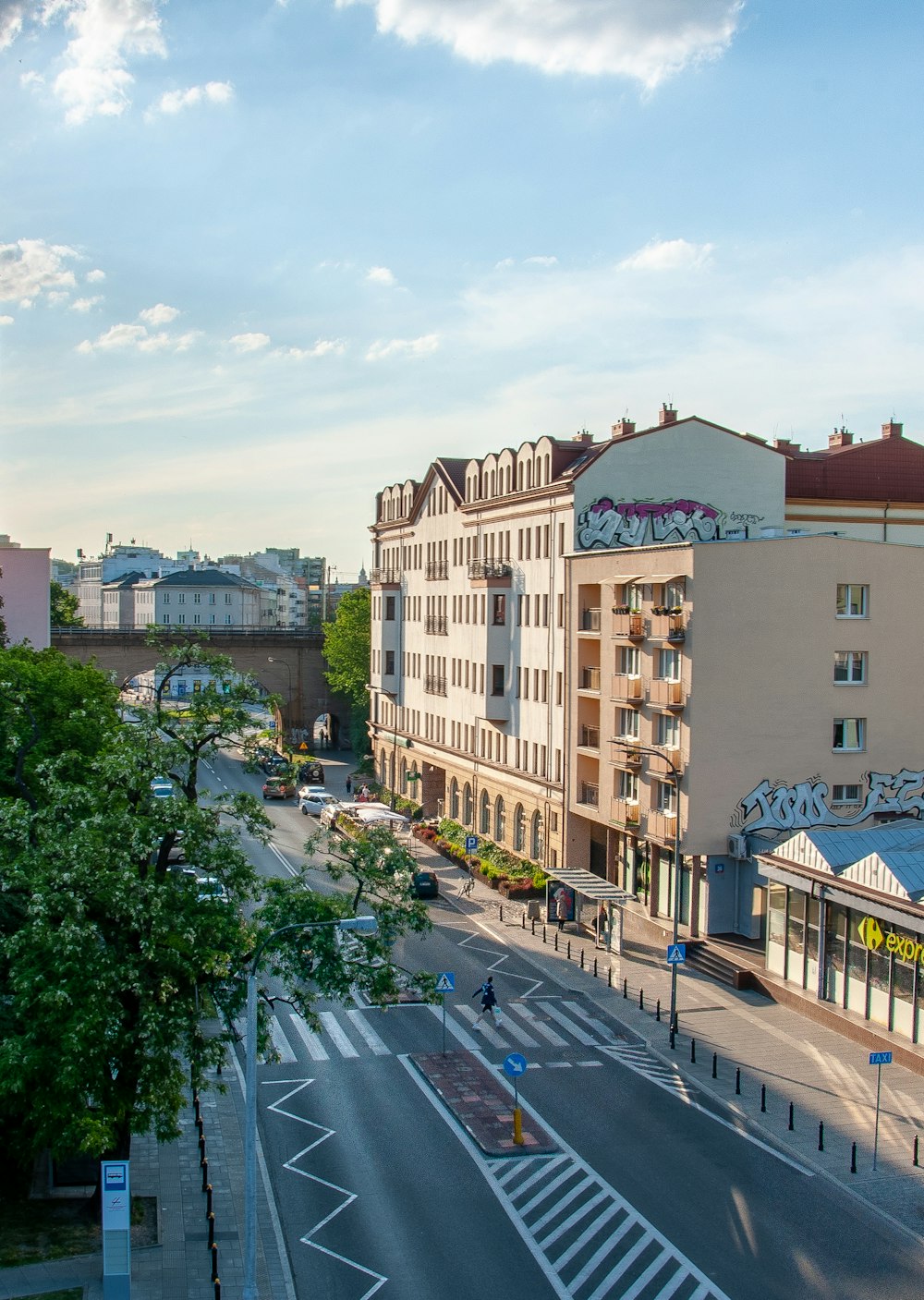 cars parked on the side of the road near buildings during daytime