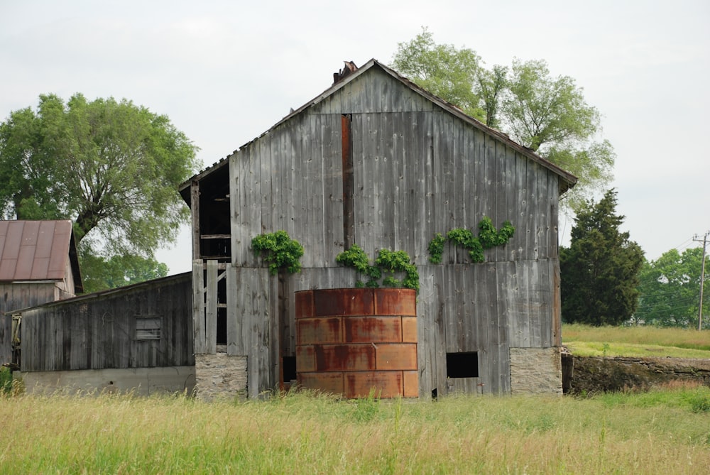 brown wooden barn on green grass field during daytime