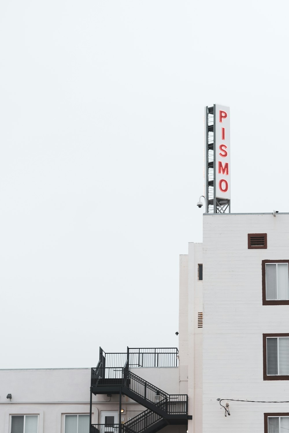 white concrete building with red and white signage