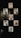 A collection of magazine covers is displayed on a dark wall, each featuring a different portrait of a person. The covers are from well-known fashion magazines such as Vogue, Grazia, and Elle. The arrangement is aesthetically pleasing and suggests a focus on fashion and style.