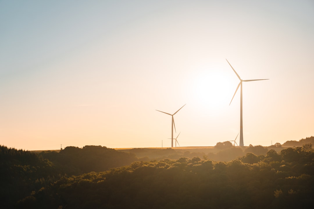 wind turbines on mountain during sunset