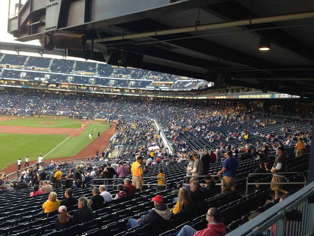 people watching football game during daytime