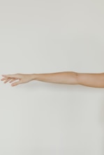 persons hand on white wall