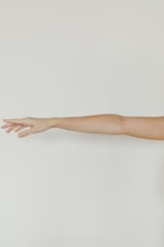 persons hand on white wall