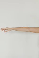 persons hand on white wall