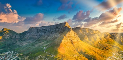 brown rocky mountain under blue sky during daytime cape town teams background