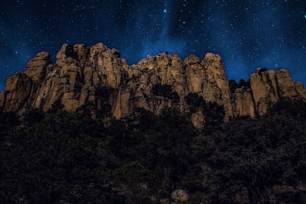 brown rocky mountain under blue sky during night time