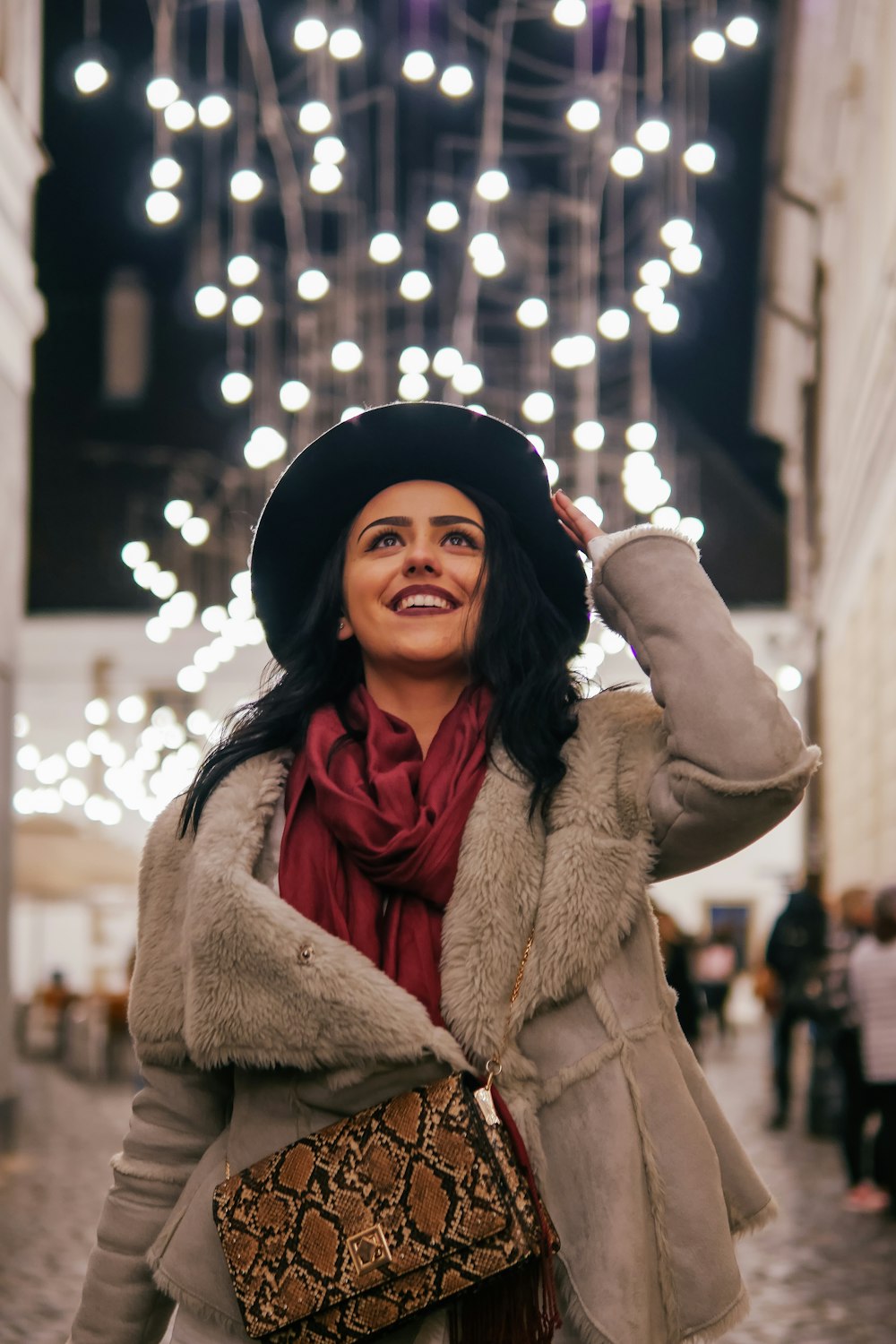 woman in brown coat and black knit cap