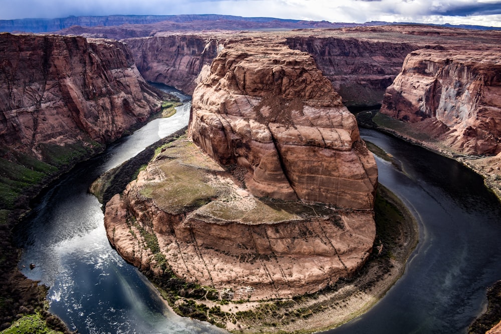 brown rock formation beside river during daytime