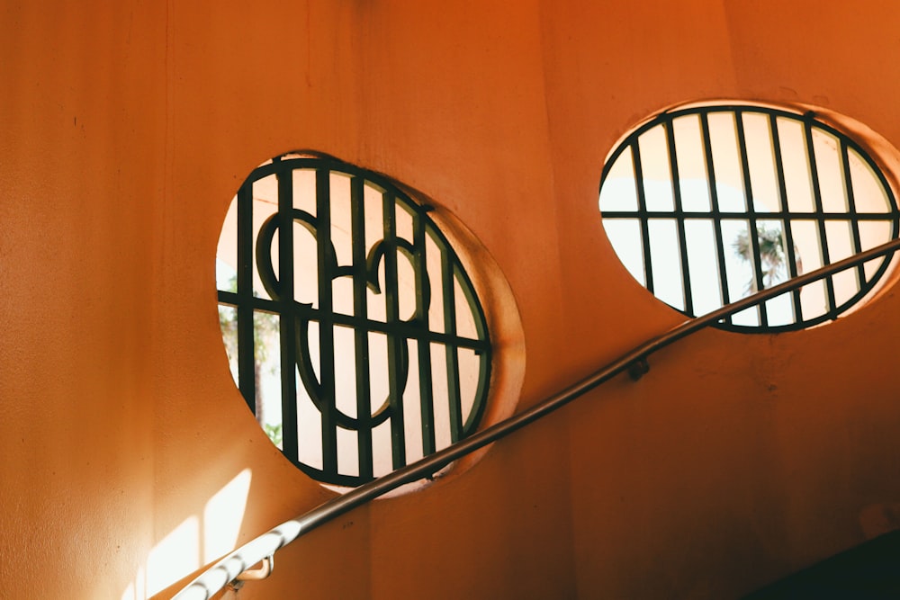 cornice rotonda in metallo nero su parete arancione