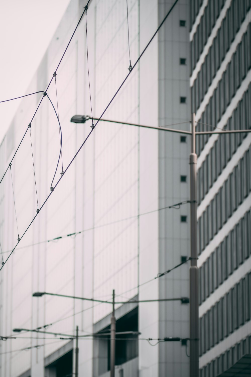 black cable wire on white concrete building during daytime