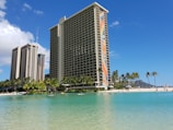 white and brown high rise building near body of water during daytime