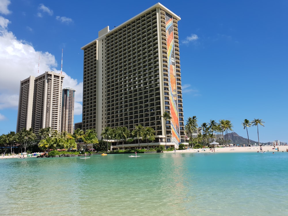 white and brown high rise building near body of water during daytime