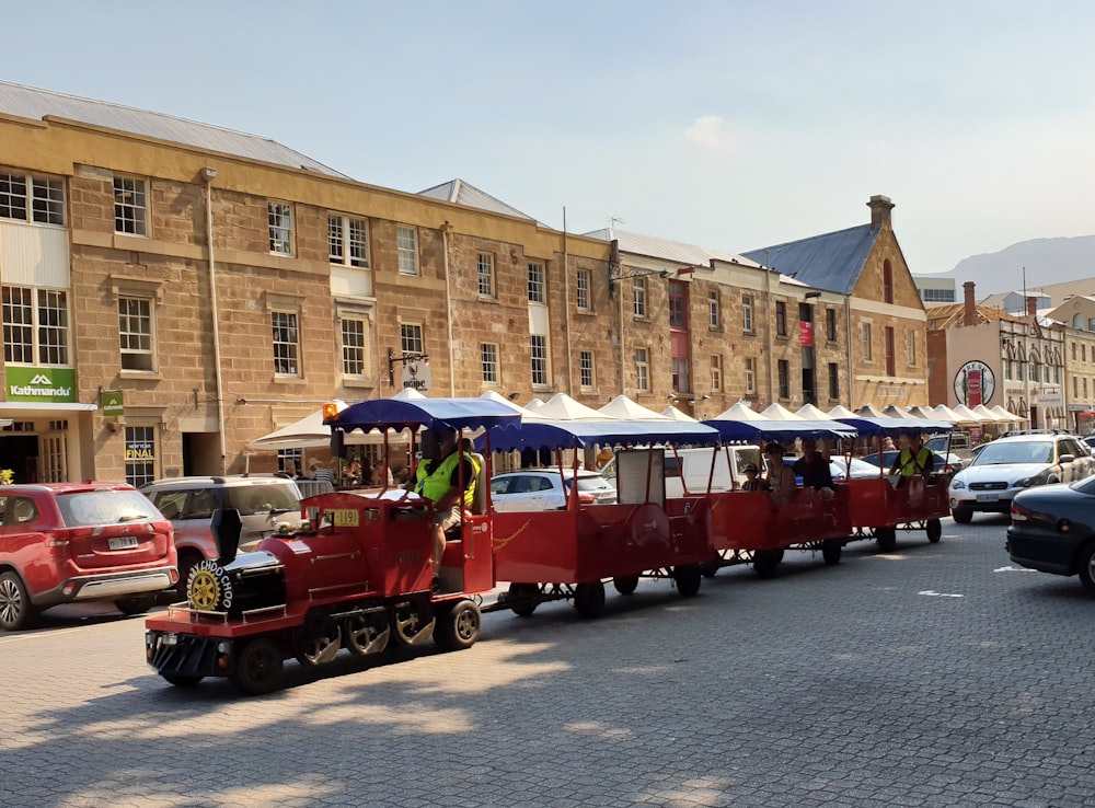 red and white train on road during daytime