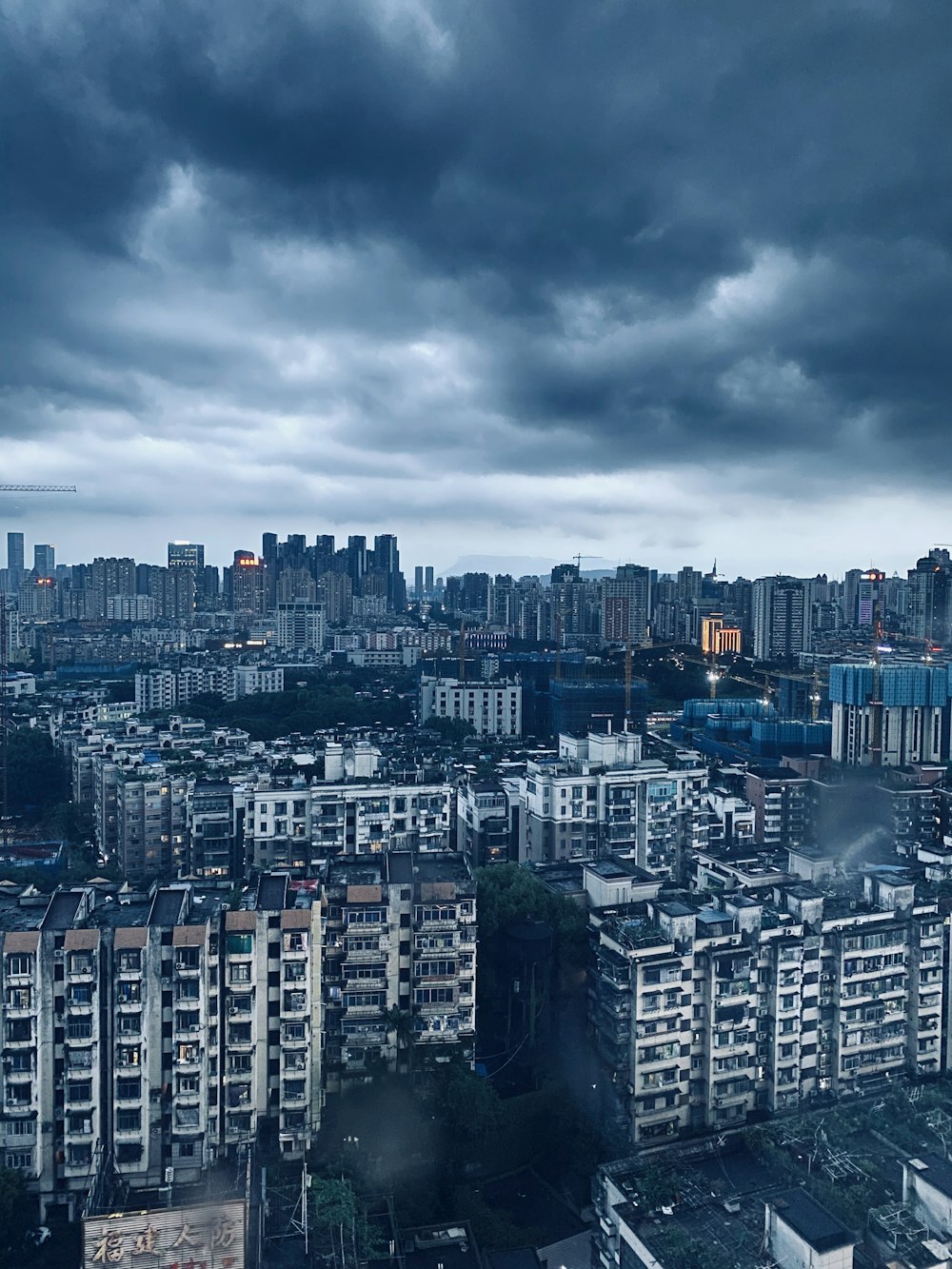 city skyline under gray cloudy sky during daytime