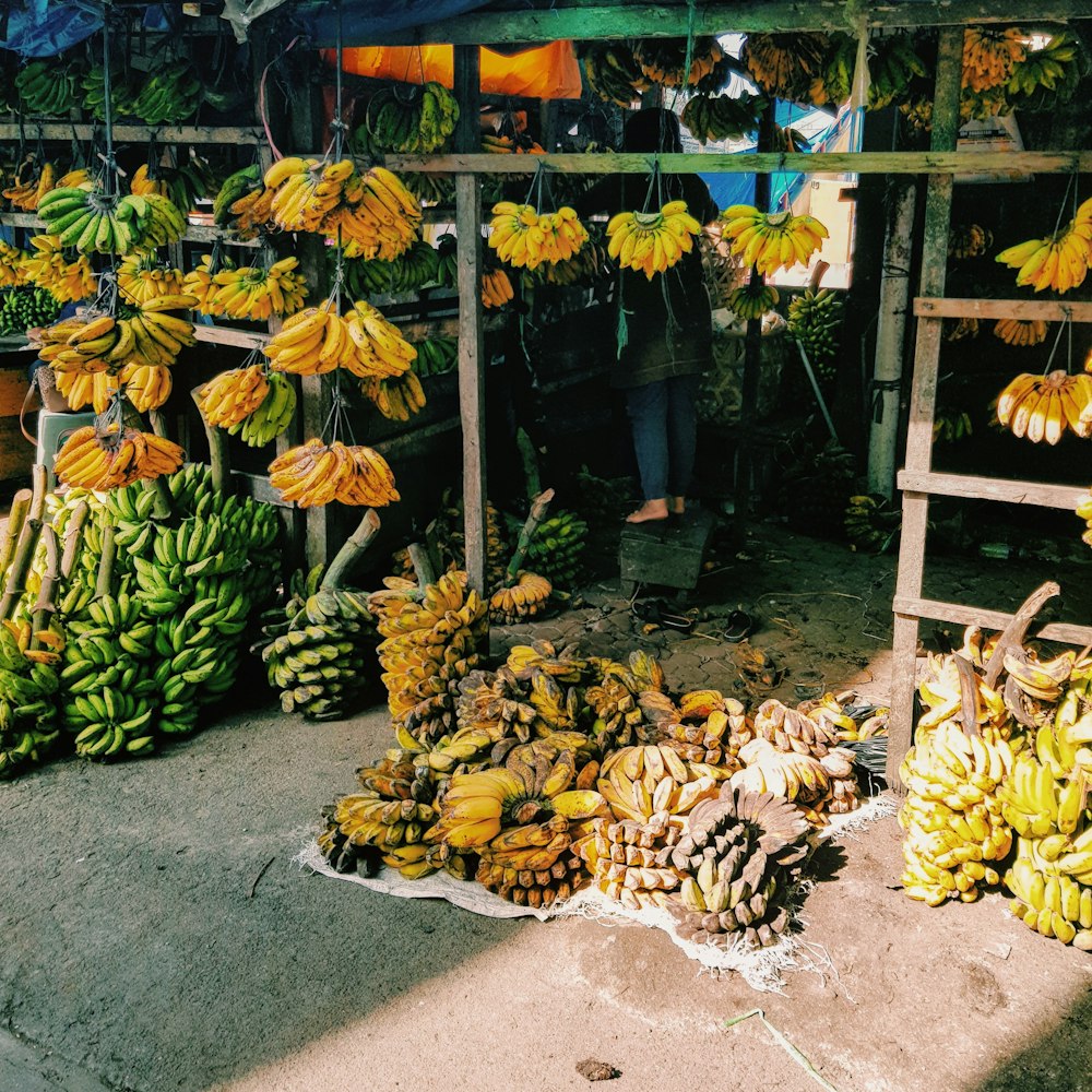 yellow banana fruit on gray concrete floor