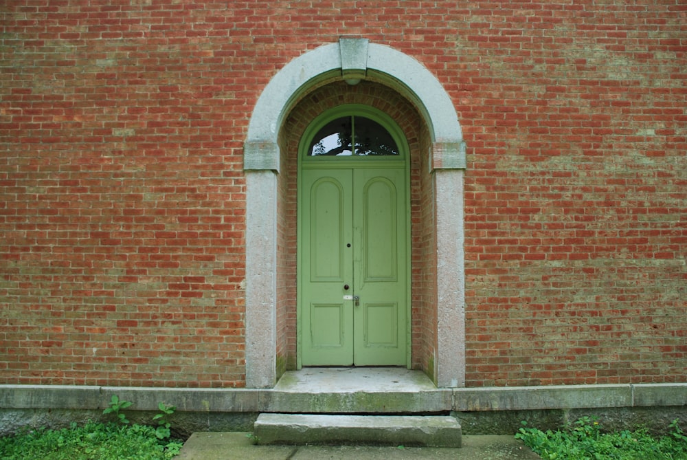 brown wooden door on brown brick wall