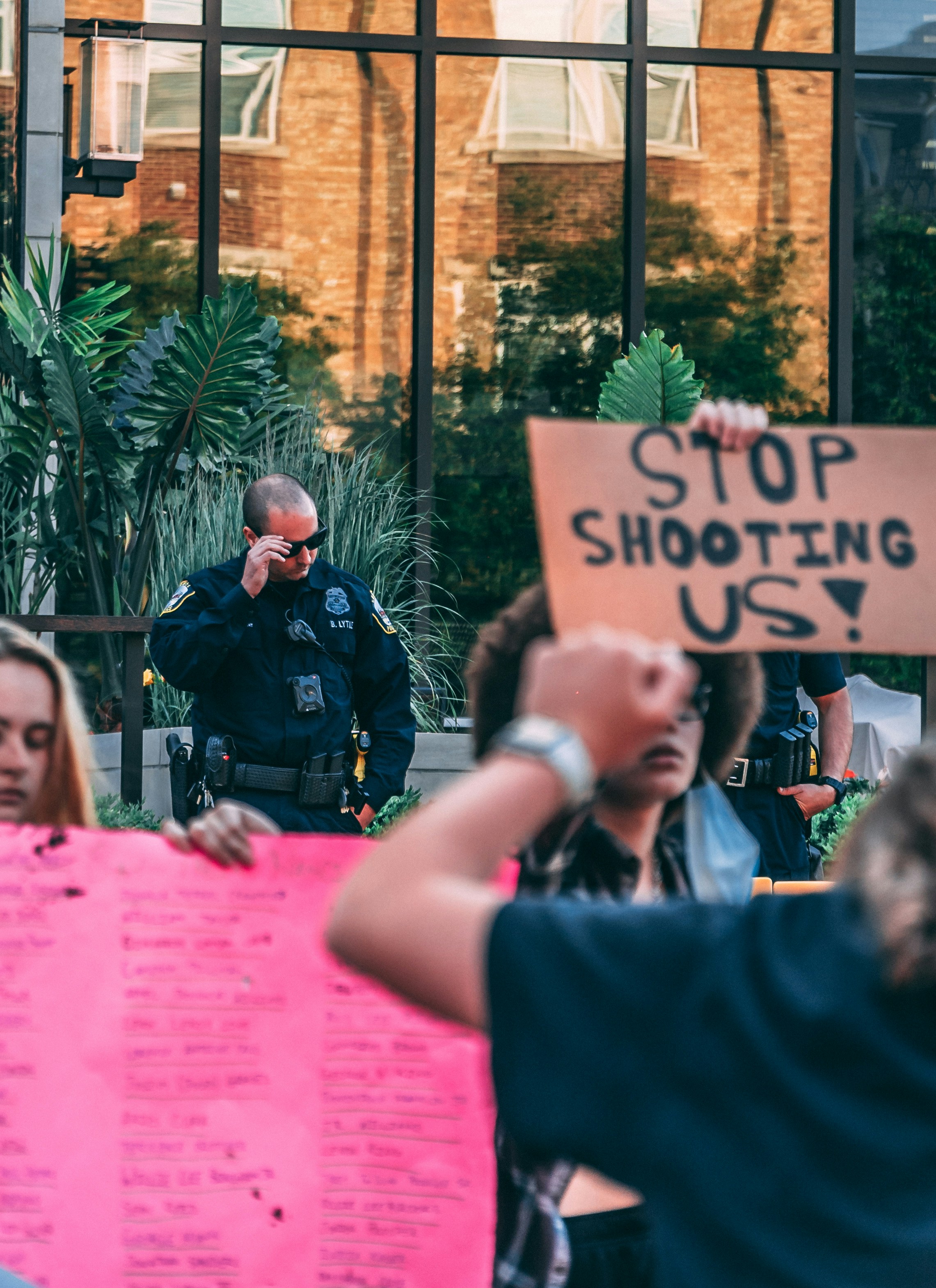 man in black shirt holding pink printer paper
