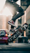 person in black pants and black and white sneakers jumping on skateboard