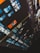 A close-up view of a video editing timeline on a computer screen with multiple video clips and tracks. Blue and orange clips are organized in a diagonal layout, and various icons and controls are visible on the interface.