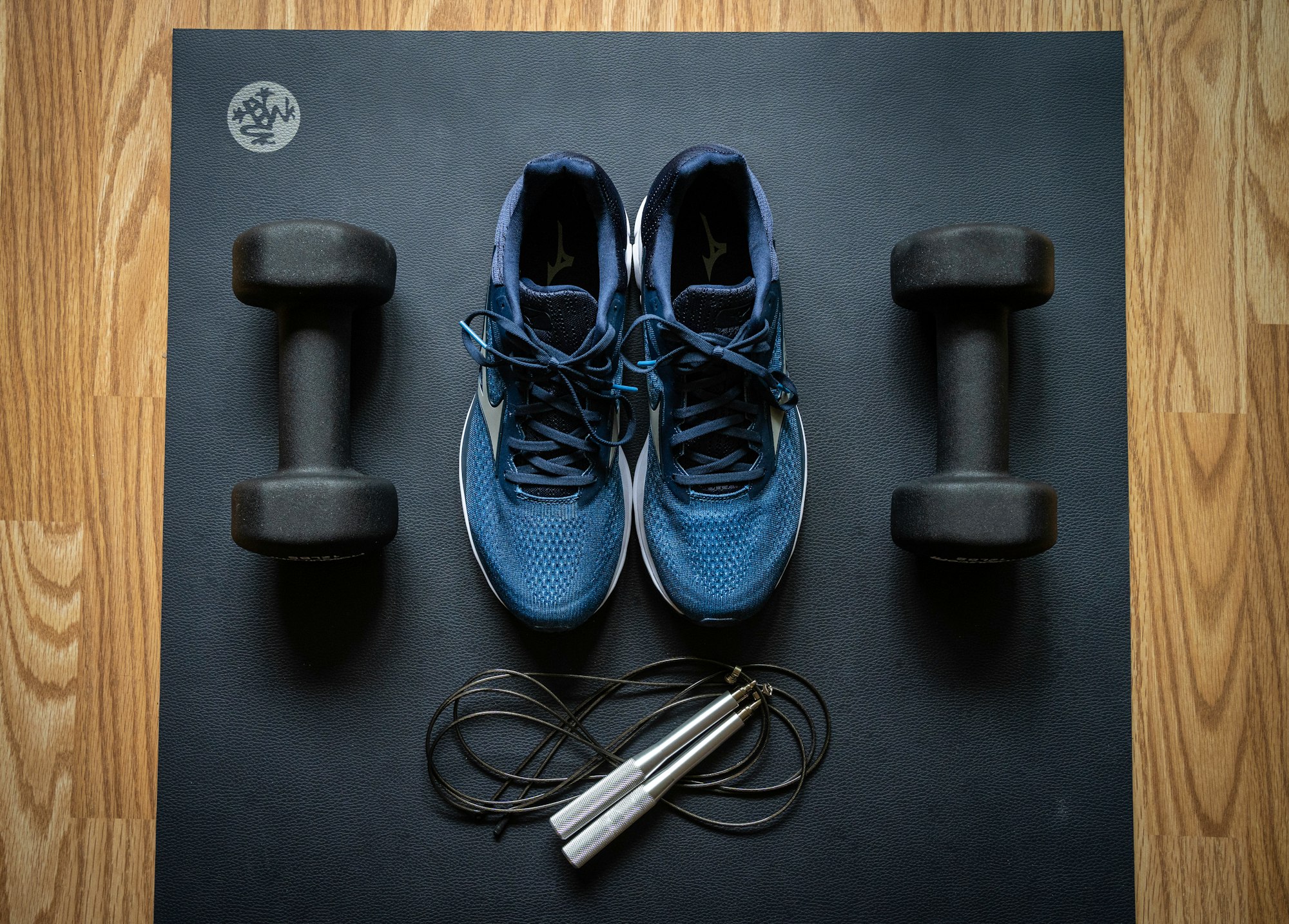 Home gym equipment by ProsourceFit dumbbells and Mizuno sneakers