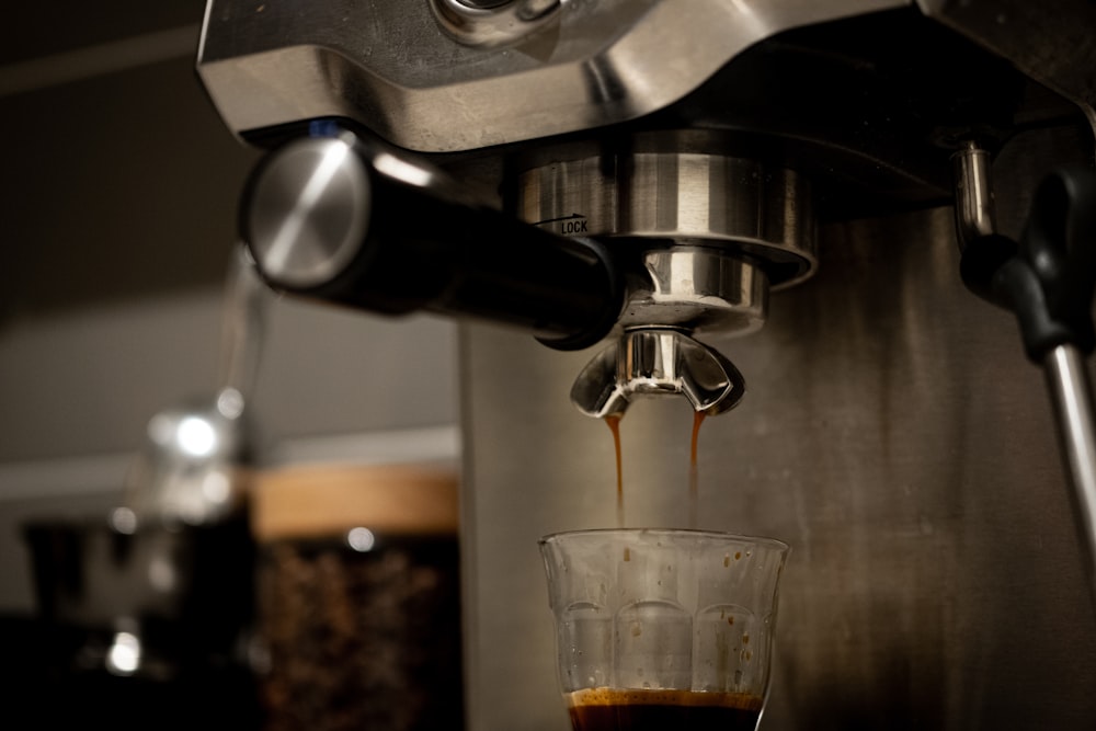 clear drinking glass on silver coffee maker