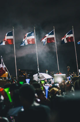 A vibrant community gathering celebrating Independence Day with flags, music, and smiling faces.